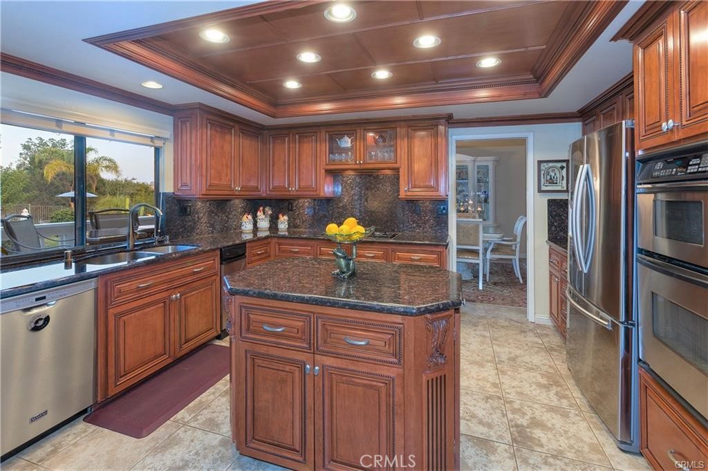 25641 Rapid Falls Road Laguna Hills, CA 92653 - Photo 29 of 50 a kitchen with stainless steel appliances granite countertop a sink a stove and a refrigerator