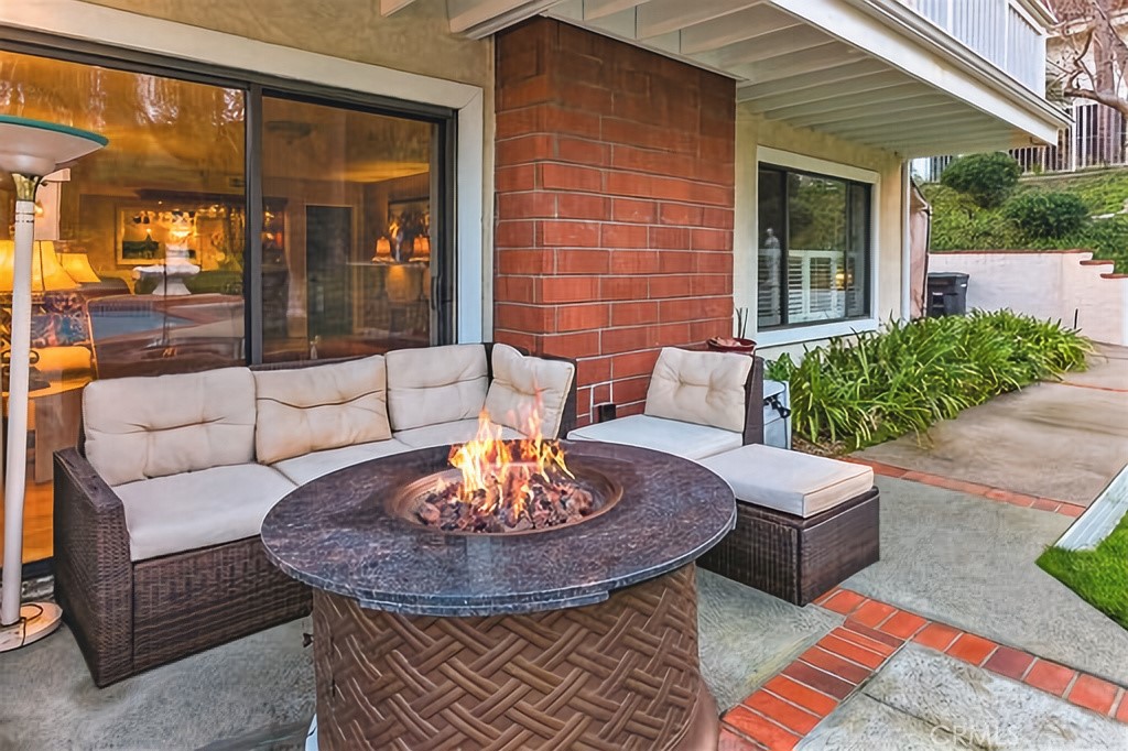 25641 Rapid Falls Road Laguna Hills, CA 92653 - Photo 31 of 50 a view of a patio with couches table and chairs and potted plants