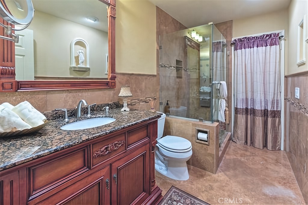 25641 Rapid Falls Road Laguna Hills, CA 92653 - Photo 33 of 50 a bathroom with a granite countertop sink and a mirror