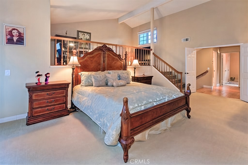 25641 Rapid Falls Road Laguna Hills, CA 92653 - Photo 35 of 50 a bedroom with furniture and a chandelier