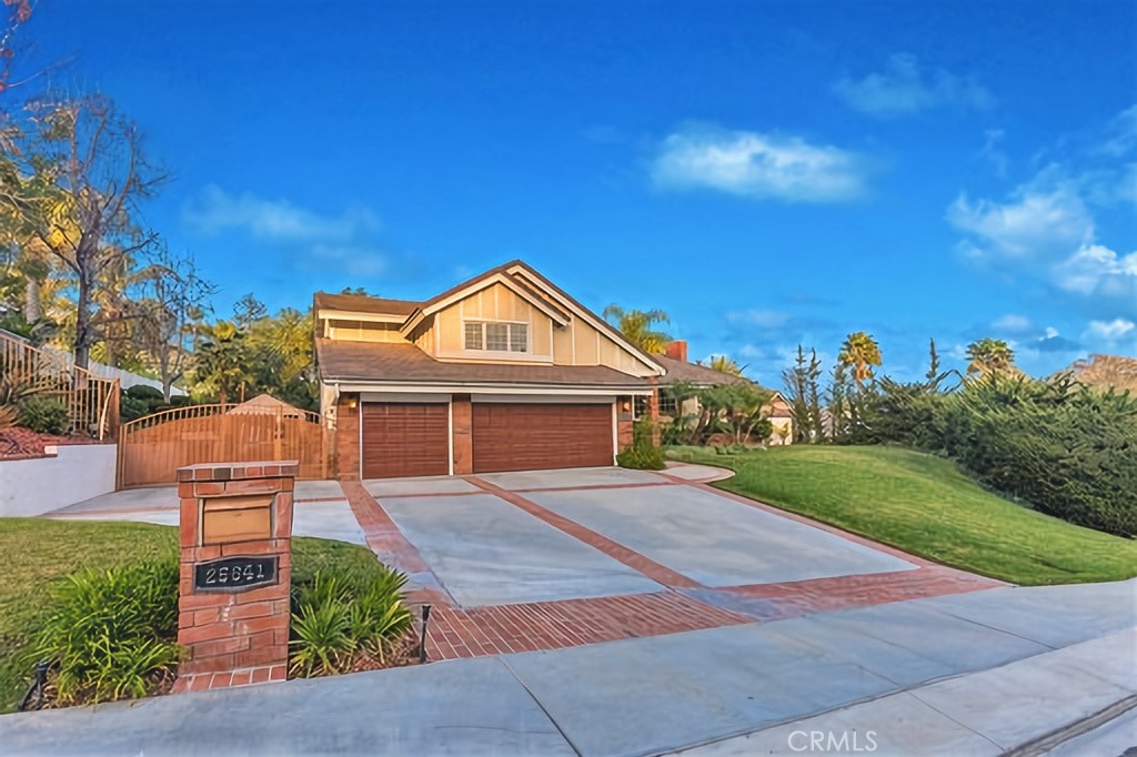 25641 Rapid Falls Road Laguna Hills, CA 92653 - Photo 4 of 50 a front view of a house with a yard and garage