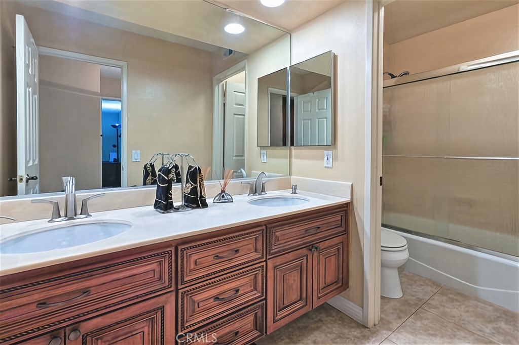 25641 Rapid Falls Road Laguna Hills, CA 92653 - Photo 44 of 50 a bathroom with a granite countertop sink toilet and shower