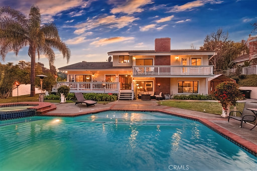 25641 Rapid Falls Road Laguna Hills, CA 92653 - Photo 7 of 50 a front view of a house with swimming pool having outdoor seating