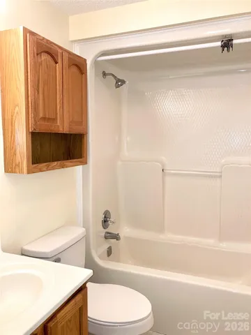 a bathroom with a toilet a sink and bathtub