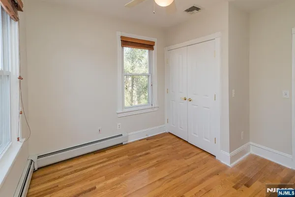 a view of a room with wooden floor and staircase