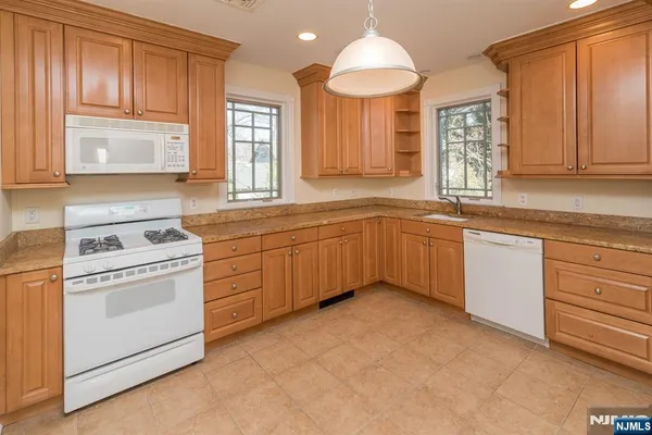 a kitchen with a sink stove and microwave