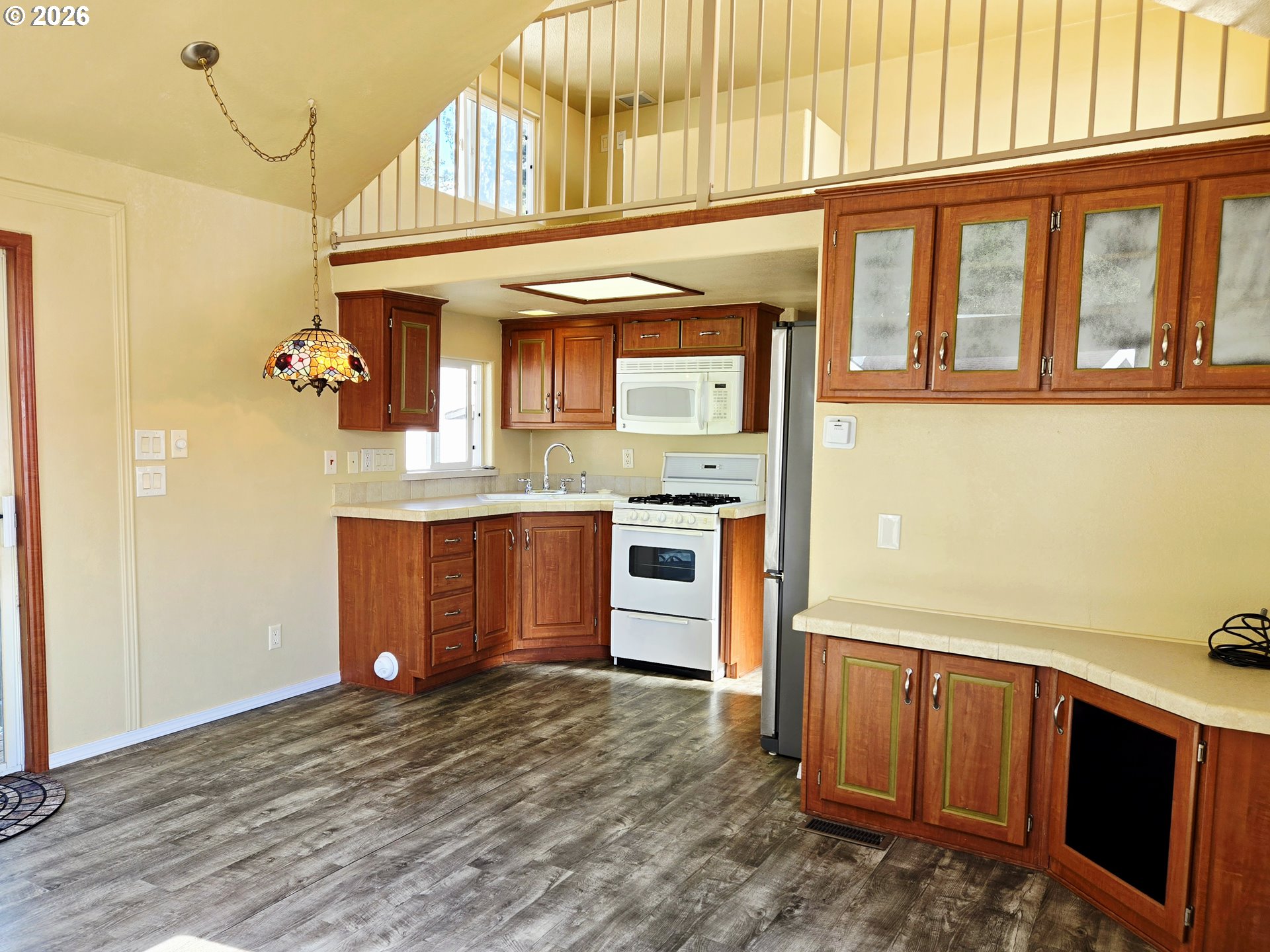 16219 Lower Harbor Road, Unit 18 Brookings, OR 97415 - Photo 16 of 38 a view of kitchen with kitchen island wooden floor and electronic appliances