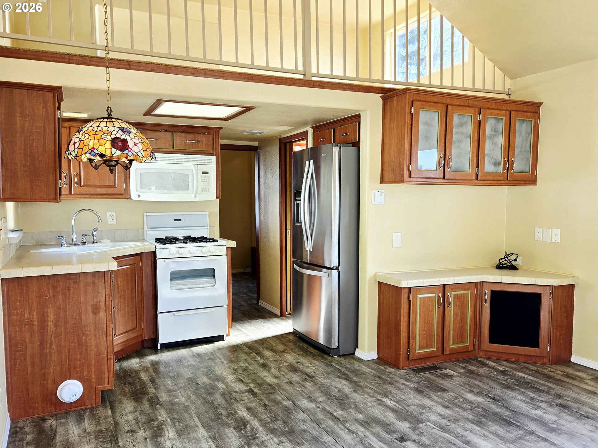 16219 Lower Harbor Road, Unit 18 Brookings, OR 97415 - Photo 17 of 38 a view of kitchen with stainless steel appliances wooden floor and more cabinets