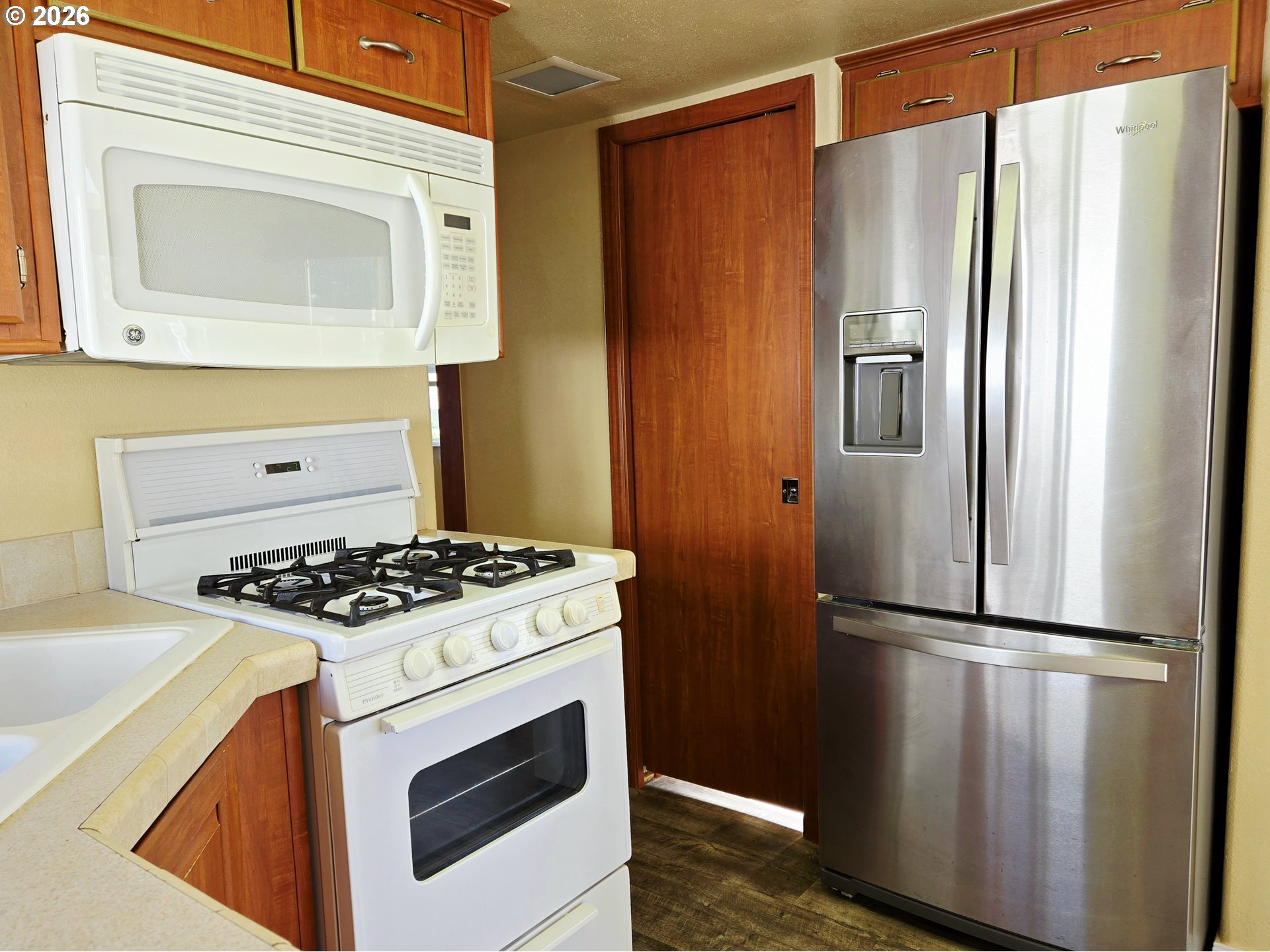16219 Lower Harbor Road, Unit 18 Brookings, OR 97415 - Photo 19 of 38 a kitchen with stainless steel appliances granite countertop a refrigerator and a stove