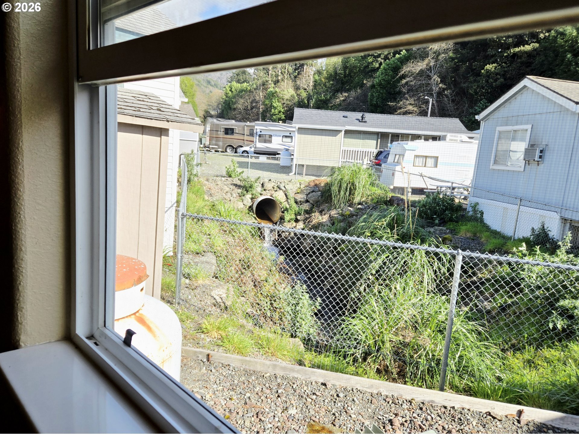 16219 Lower Harbor Road, Unit 18 Brookings, OR 97415 - Photo 26 of 38 a view of a yard from a window