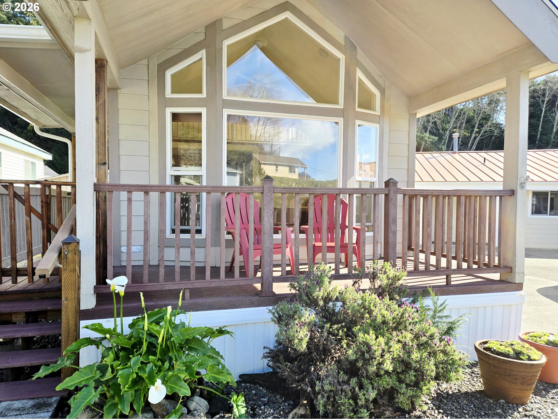 16219 Lower Harbor Road, Unit 18 Brookings, OR 97415 - Photo 3 of 38 a view of a house with a backyard and sitting area