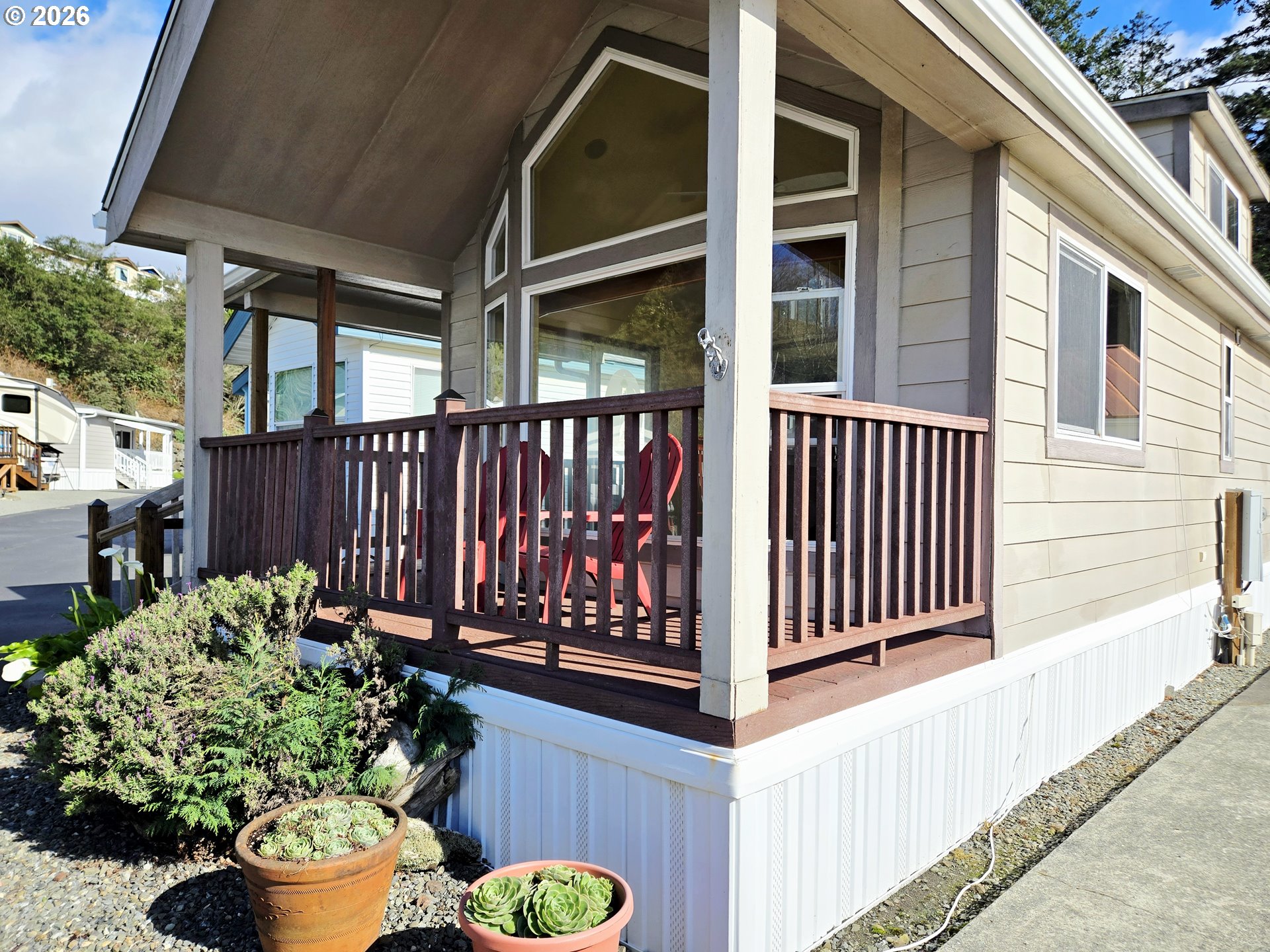 16219 Lower Harbor Road, Unit 18 Brookings, OR 97415 - Photo 31 of 38 a view of a porch with a bench