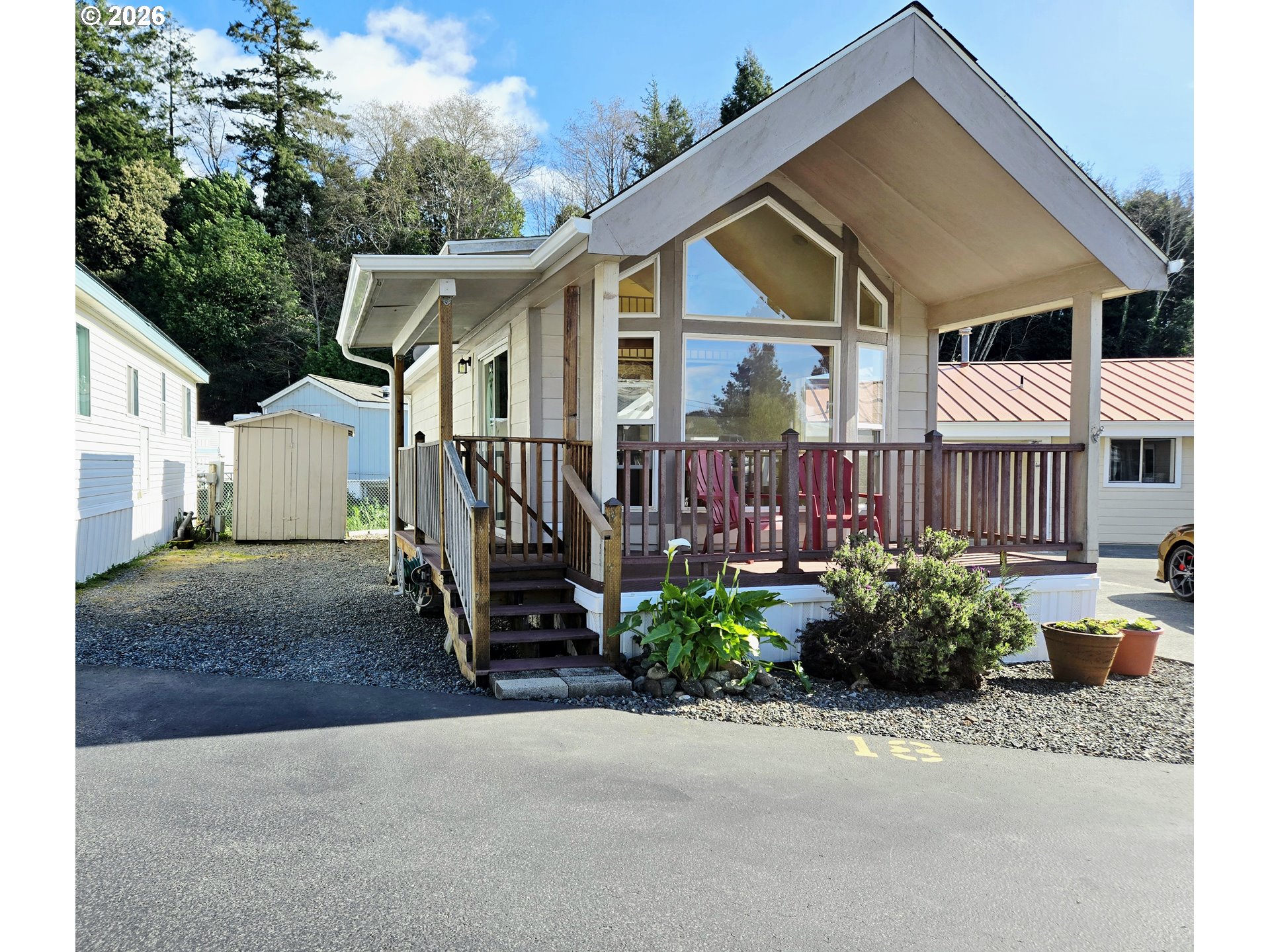16219 Lower Harbor Road, Unit 18 Brookings, OR 97415 - Photo 32 of 38 a view of a house with a garden and pathway