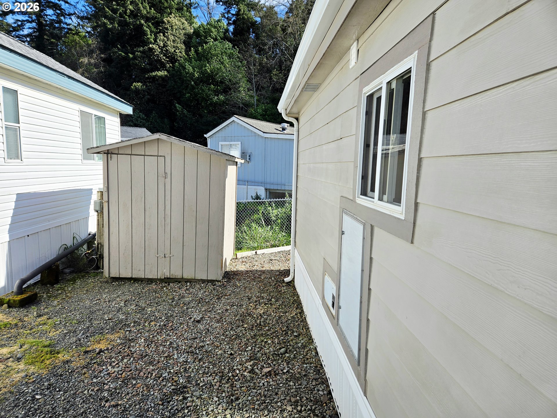 16219 Lower Harbor Road, Unit 18 Brookings, OR 97415 - Photo 33 of 38 a view of a house with backyard and porch