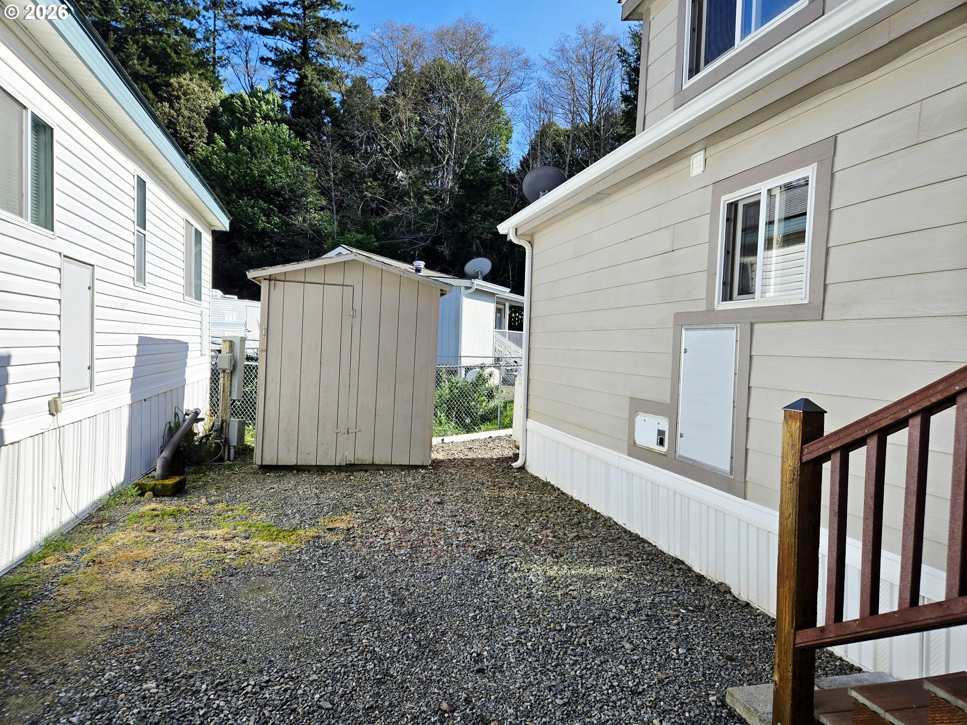 16219 Lower Harbor Road, Unit 18 Brookings, OR 97415 - Photo 5 of 38 a view of a house with backyard and tree