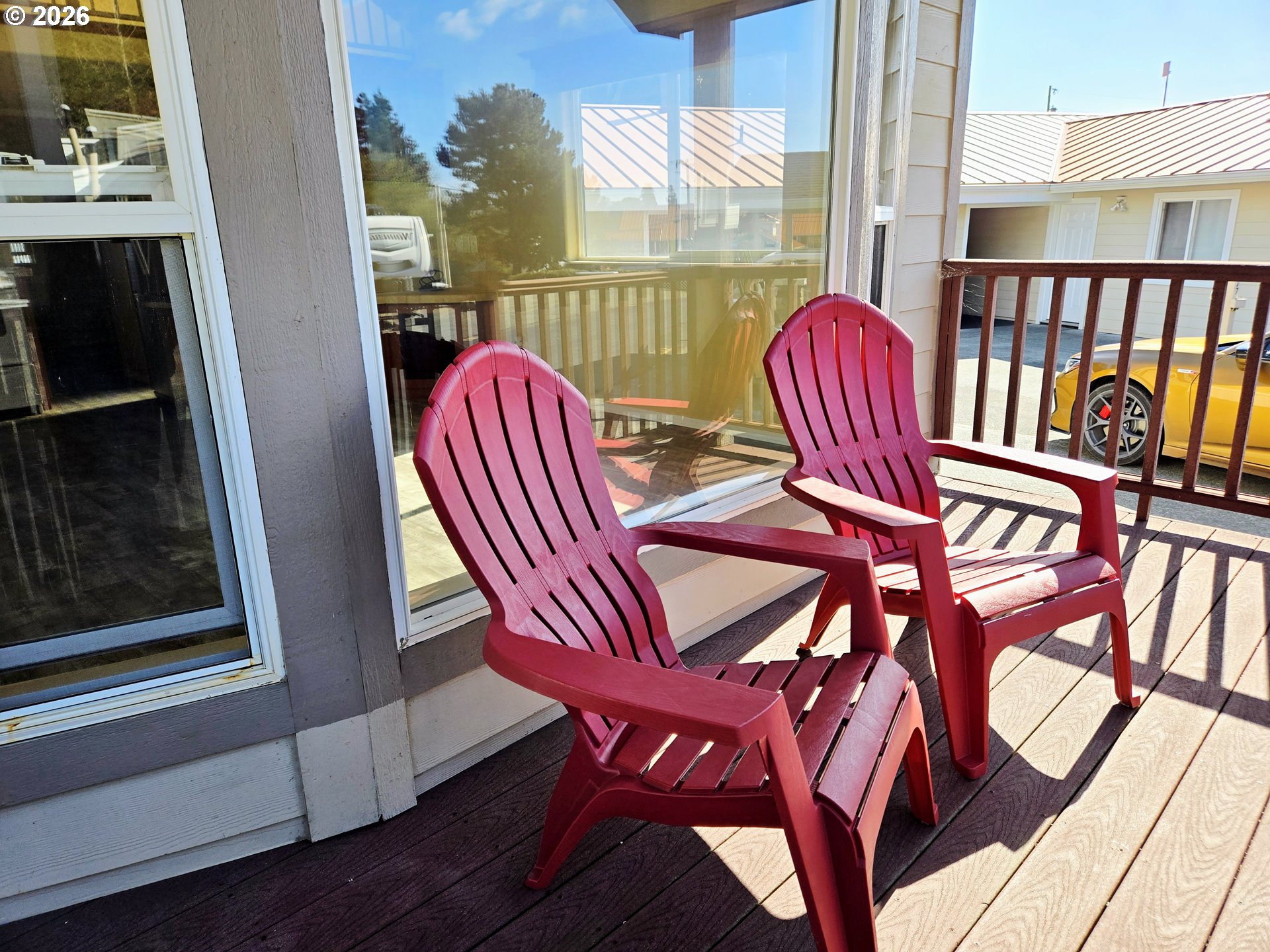16219 Lower Harbor Road, Unit 18 Brookings, OR 97415 - Photo 10 of 38 a view of a balcony with furniture and wooden floor