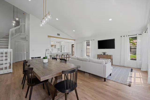 a view of a dining room with furniture and wooden floor