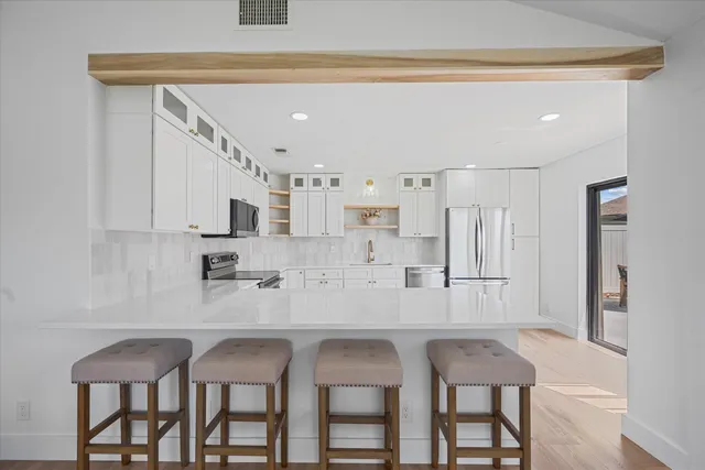 a kitchen with stainless steel appliances granite countertop a sink and cabinets