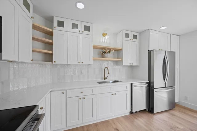 a bathroom with a granite countertop toilet and a sink