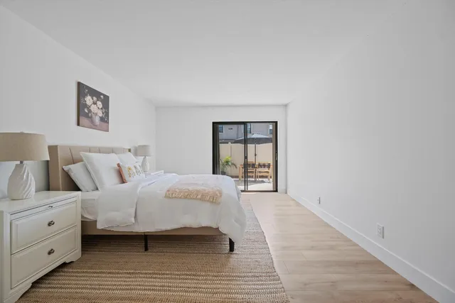 a bedroom with a bed and a painting on the wall