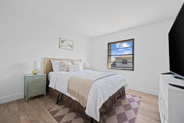 a bedroom with a bed and a flat screen tv