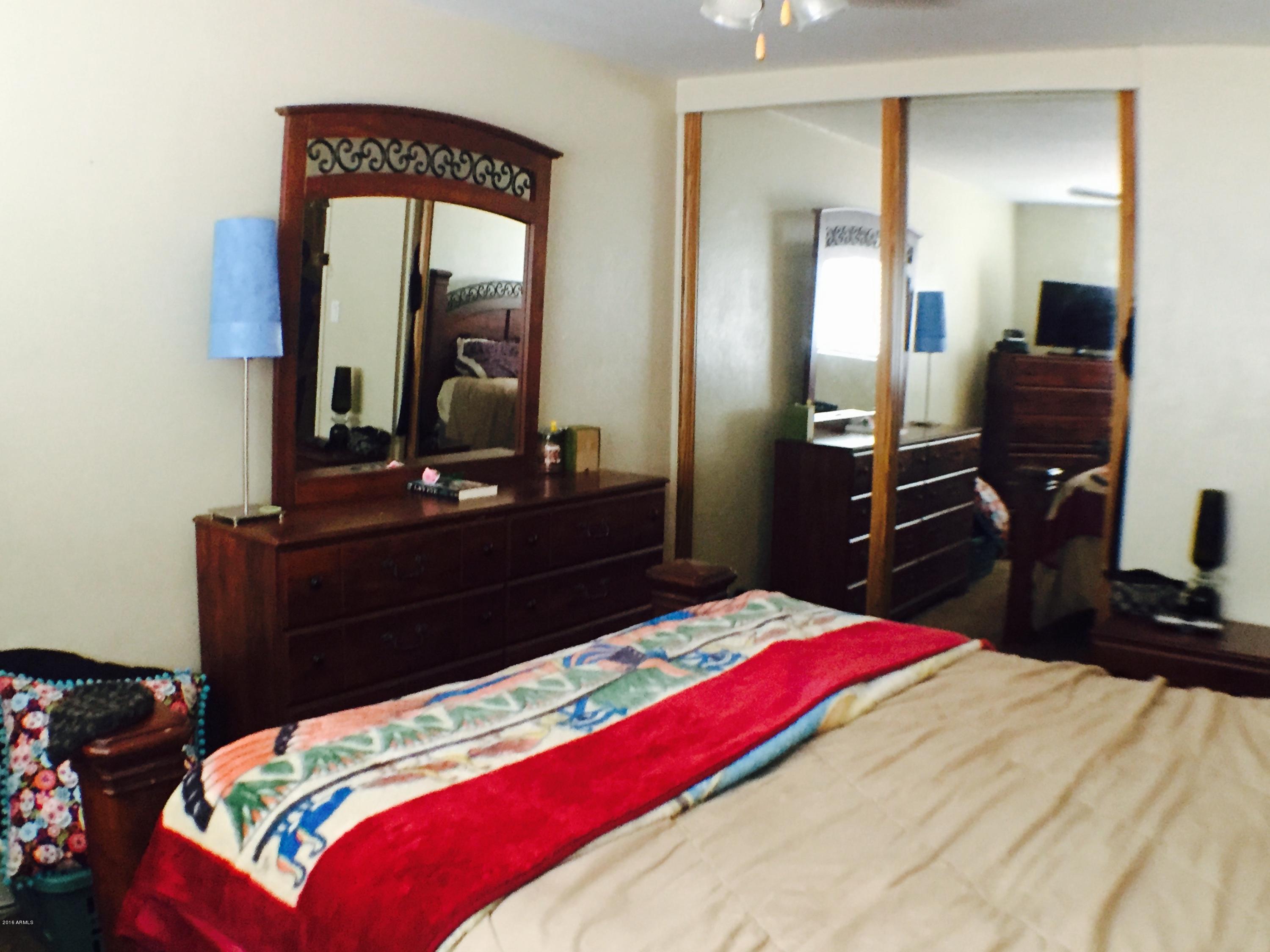 3401 West Ocotillo Road Phoenix, AZ 85017 - Photo 14 of 19 a bedroom with a bed and a dresser