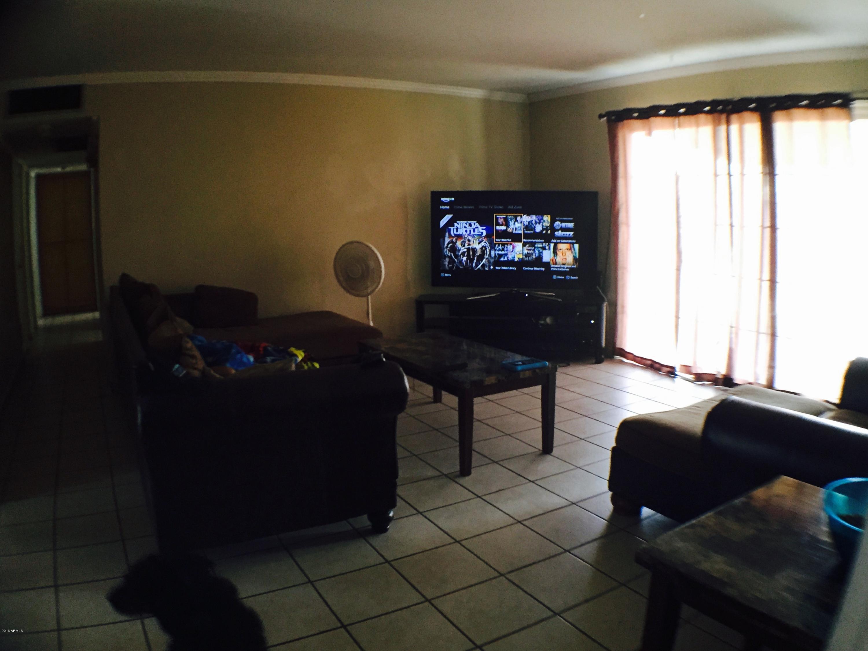 3401 West Ocotillo Road Phoenix, AZ 85017 - Photo 6 of 19 a living room with furniture and a flat screen tv