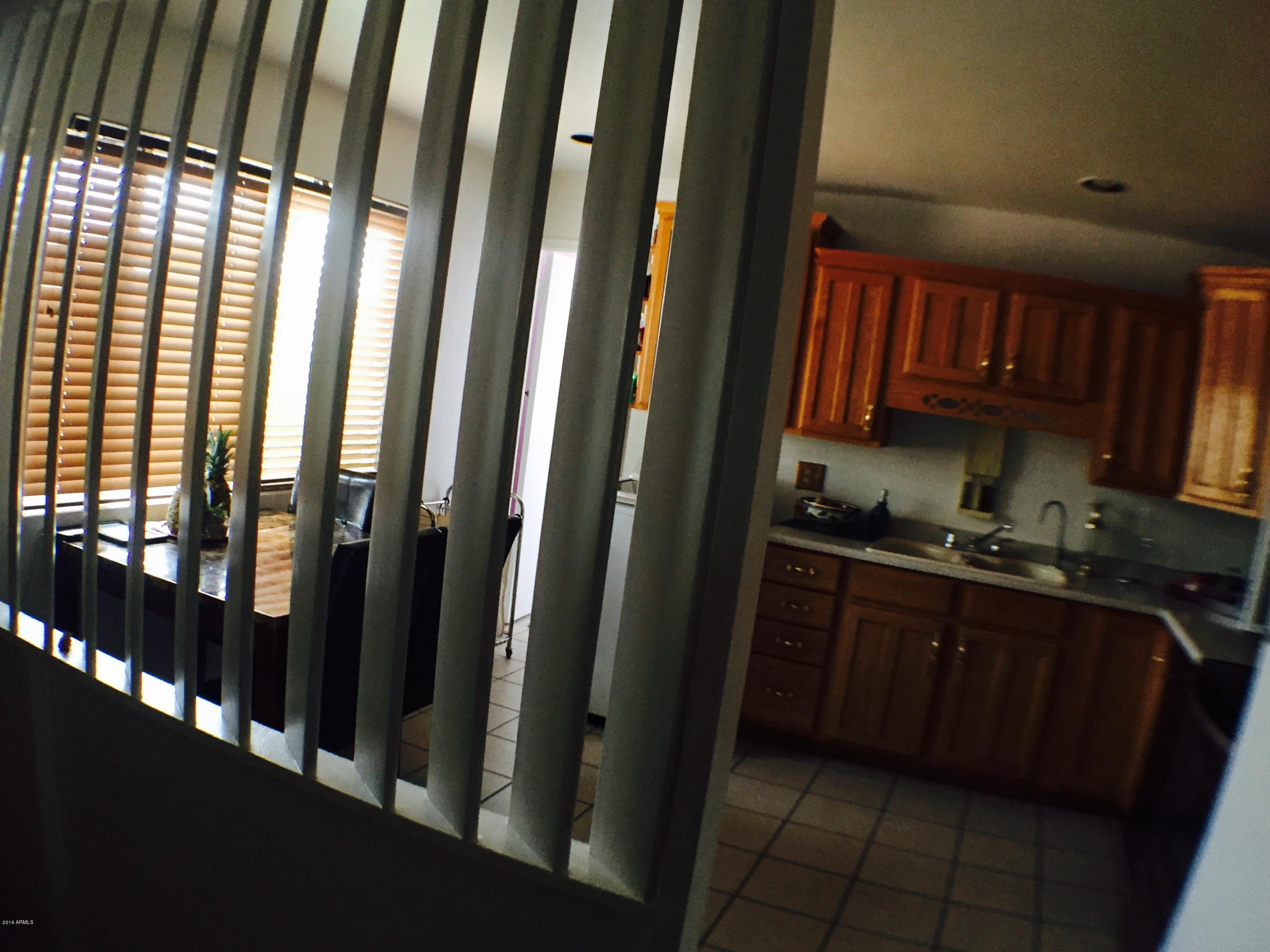 3401 West Ocotillo Road Phoenix, AZ 85017 - Photo 8 of 19 a kitchen with granite countertop a refrigerator and a sink