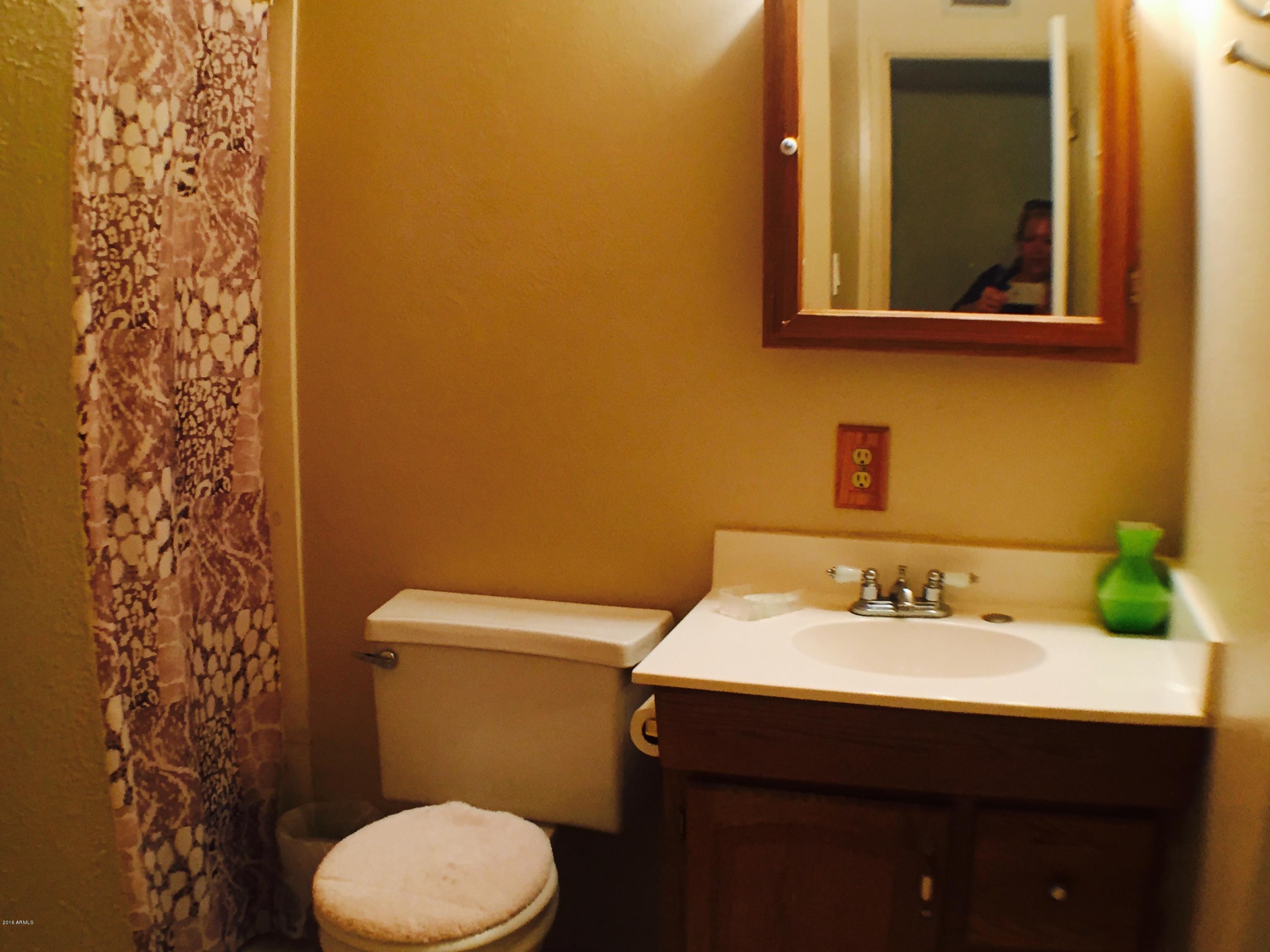 3401 West Ocotillo Road Phoenix, AZ 85017 - Photo 9 of 19 a bathroom with a sink mirror and toilet
