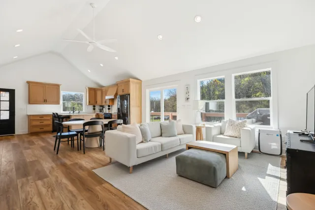 a spacious bedroom with a bed and wooden floor