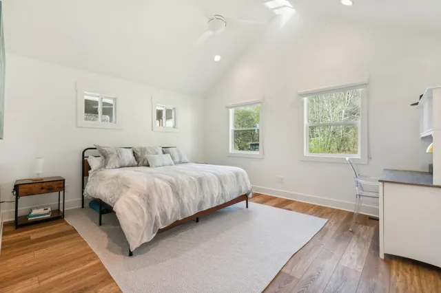 a spacious bathroom with a double vanity sink a mirror and a bathtub
