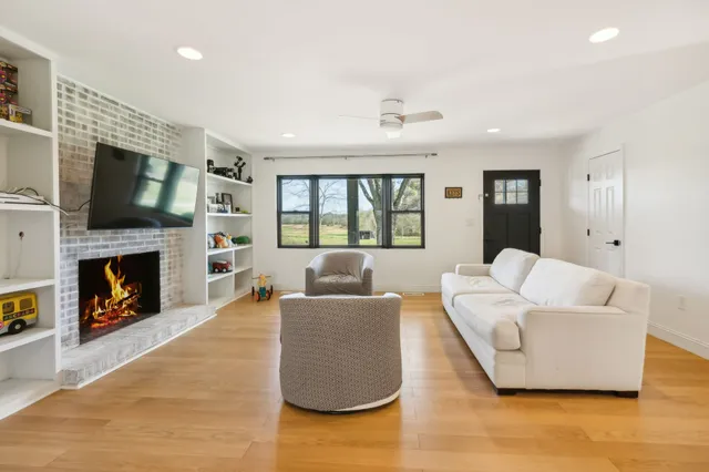 a bathroom with a bathtub shower sink mirror and toilet