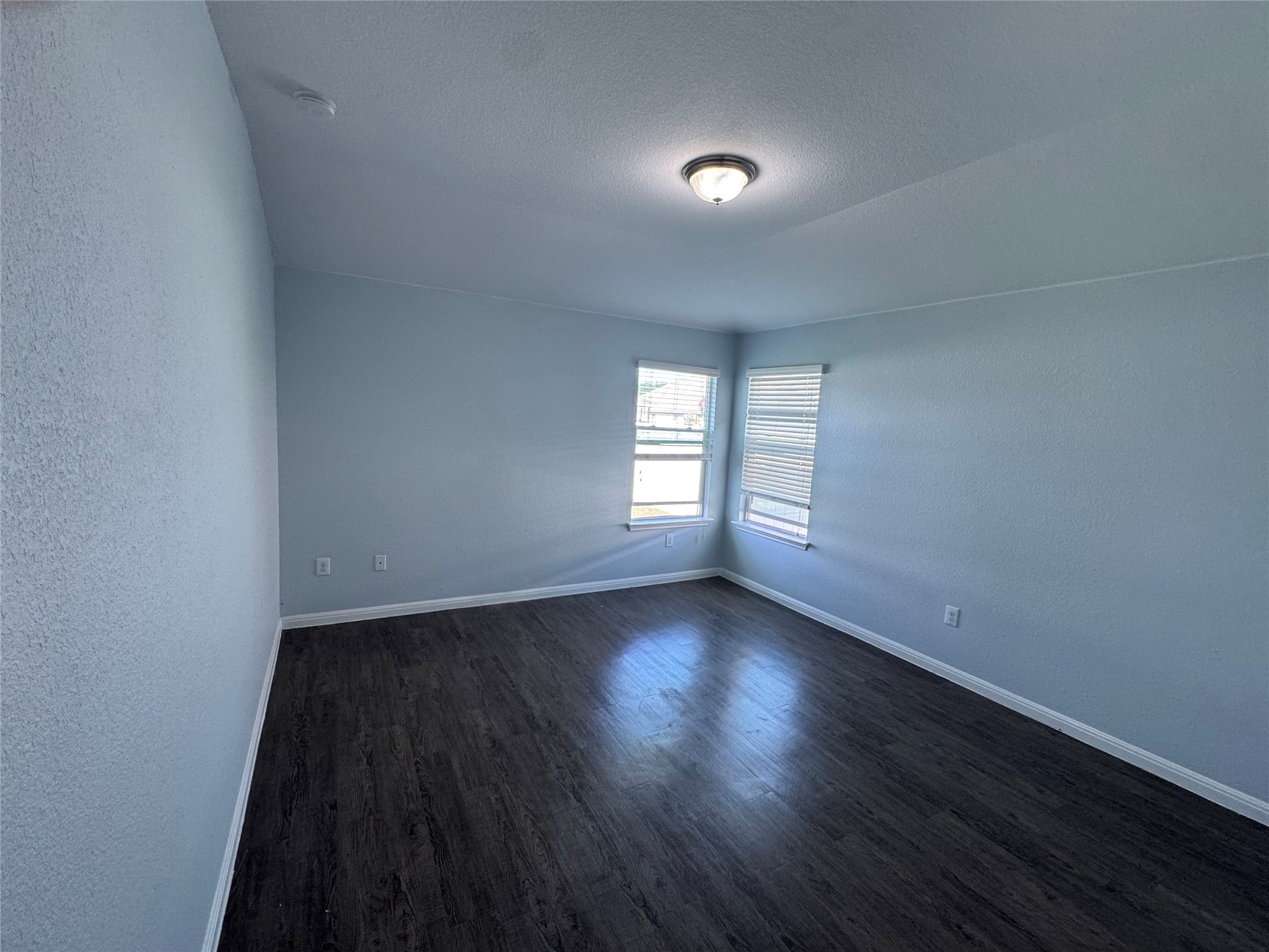 1520 Portchester Castle Path Pflugerville, TX 78660 - Photo 17 of 26 Ample natural light illuminates this generously proportioned room with rich, dark hardwood flooring.
