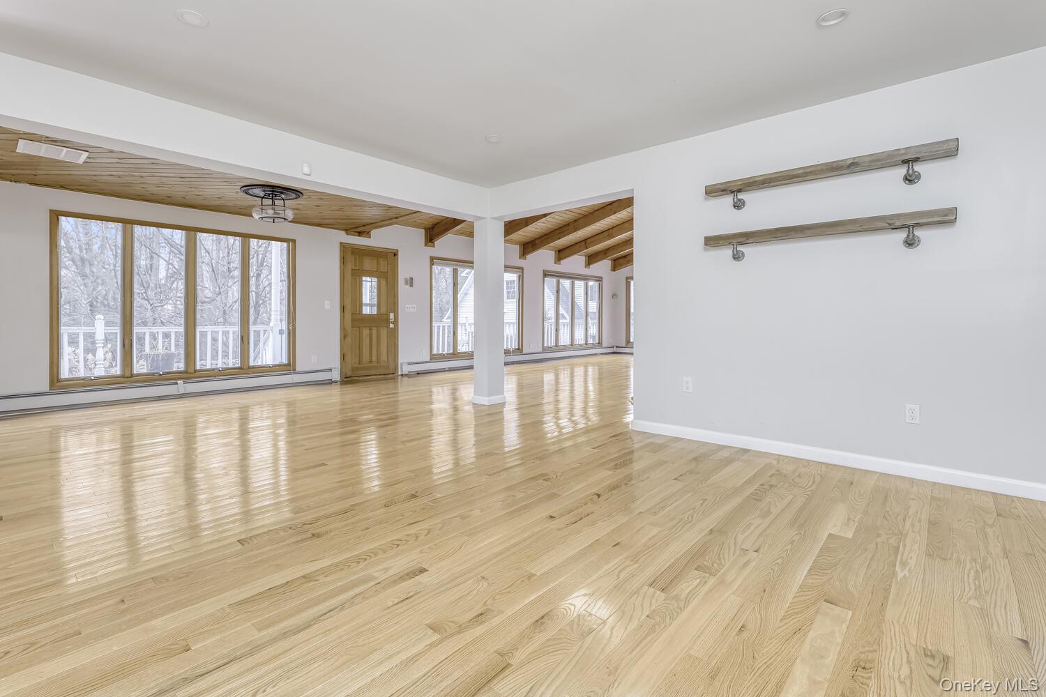 121 Thiells Road Stony Point, NY 10980 - Photo 11 of 34 a view of an empty room with wooden floor and a window