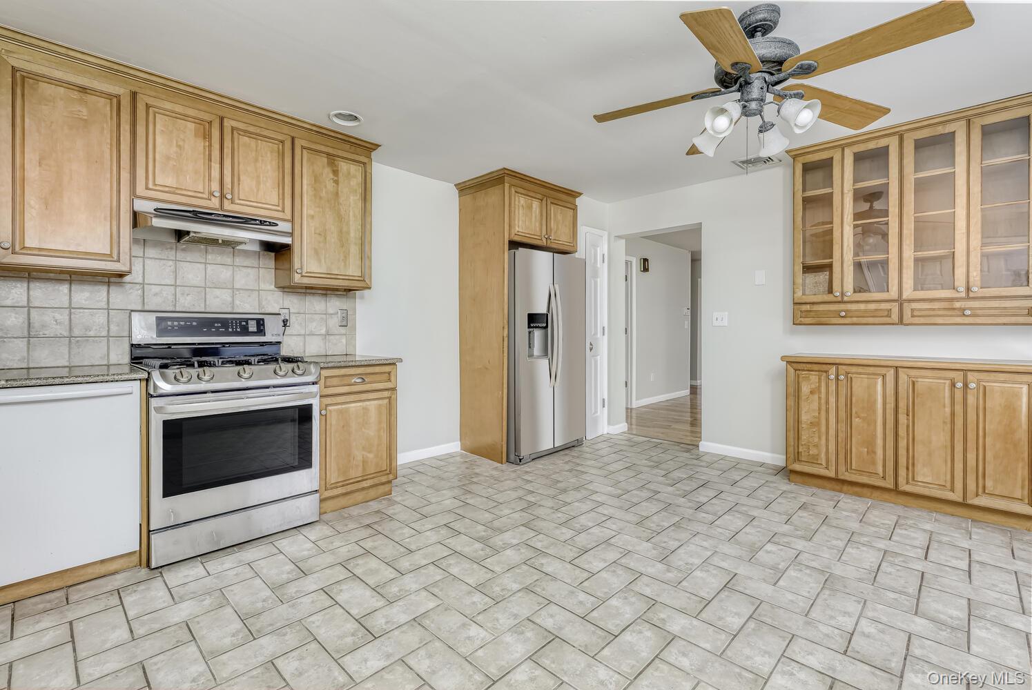 121 Thiells Road Stony Point, NY 10980 - Photo 14 of 34 a kitchen with granite countertop a stove a sink and a refrigerator