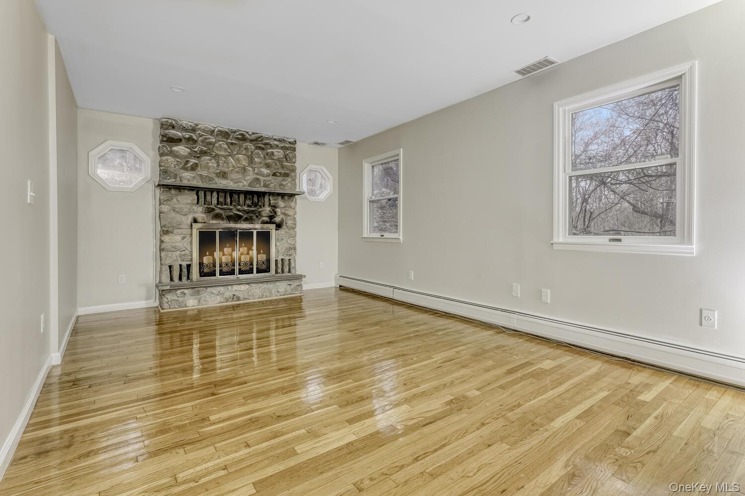 121 Thiells Road Stony Point, NY 10980 - Photo 16 of 34 a view of an empty room with a fireplace and a window