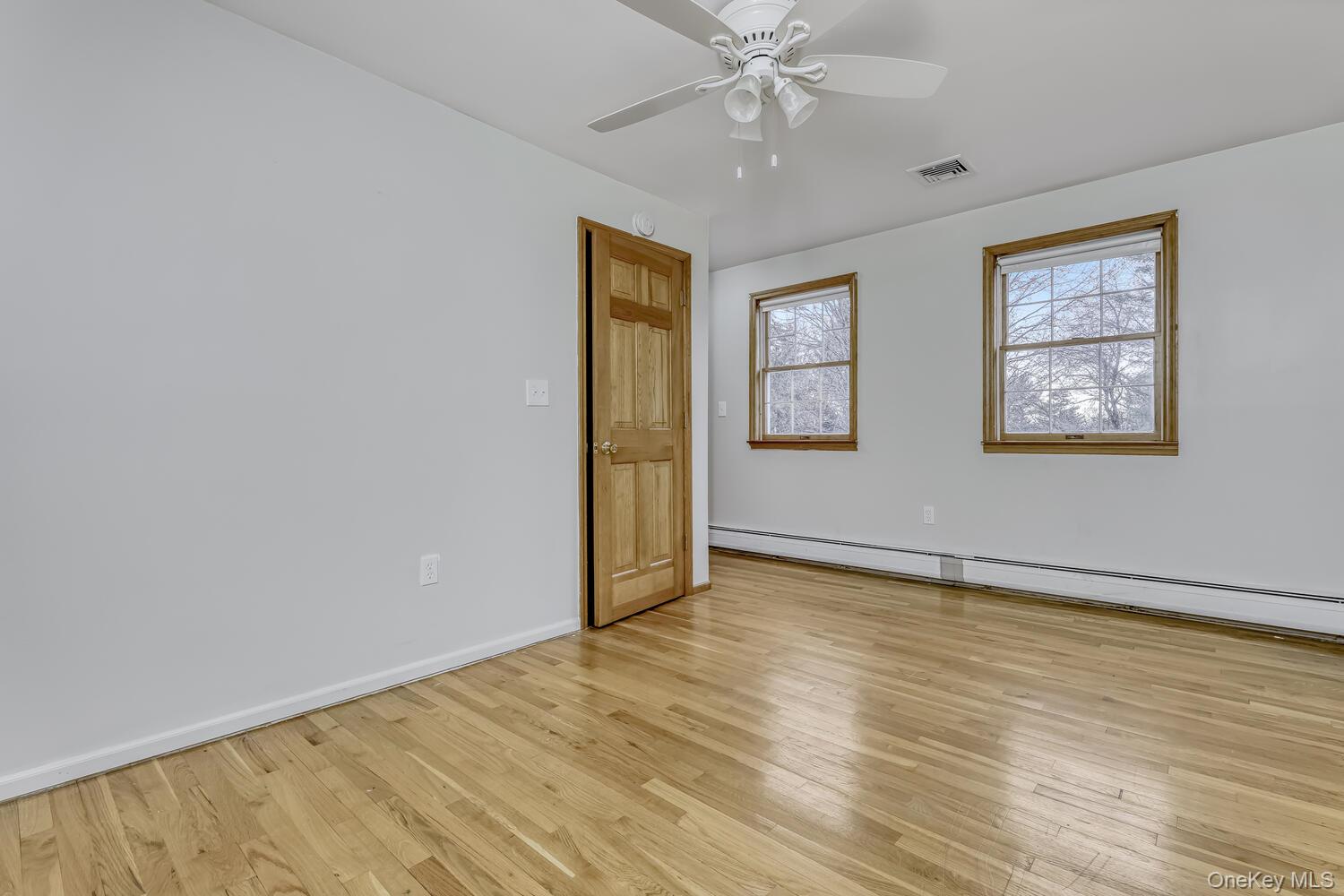 121 Thiells Road Stony Point, NY 10980 - Photo 17 of 34 a view of an empty room with wooden floor and a window