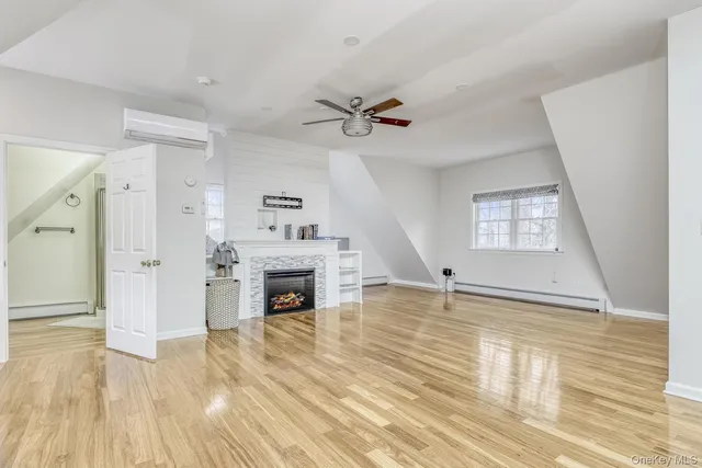 wooden floor fireplace and windows in a room