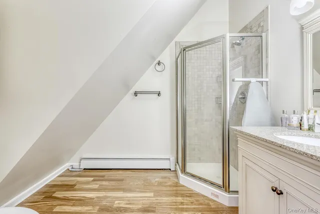 a bathroom with a granite countertop sink and a mirror