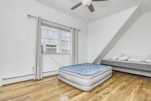 a living room with couch dining table and a window