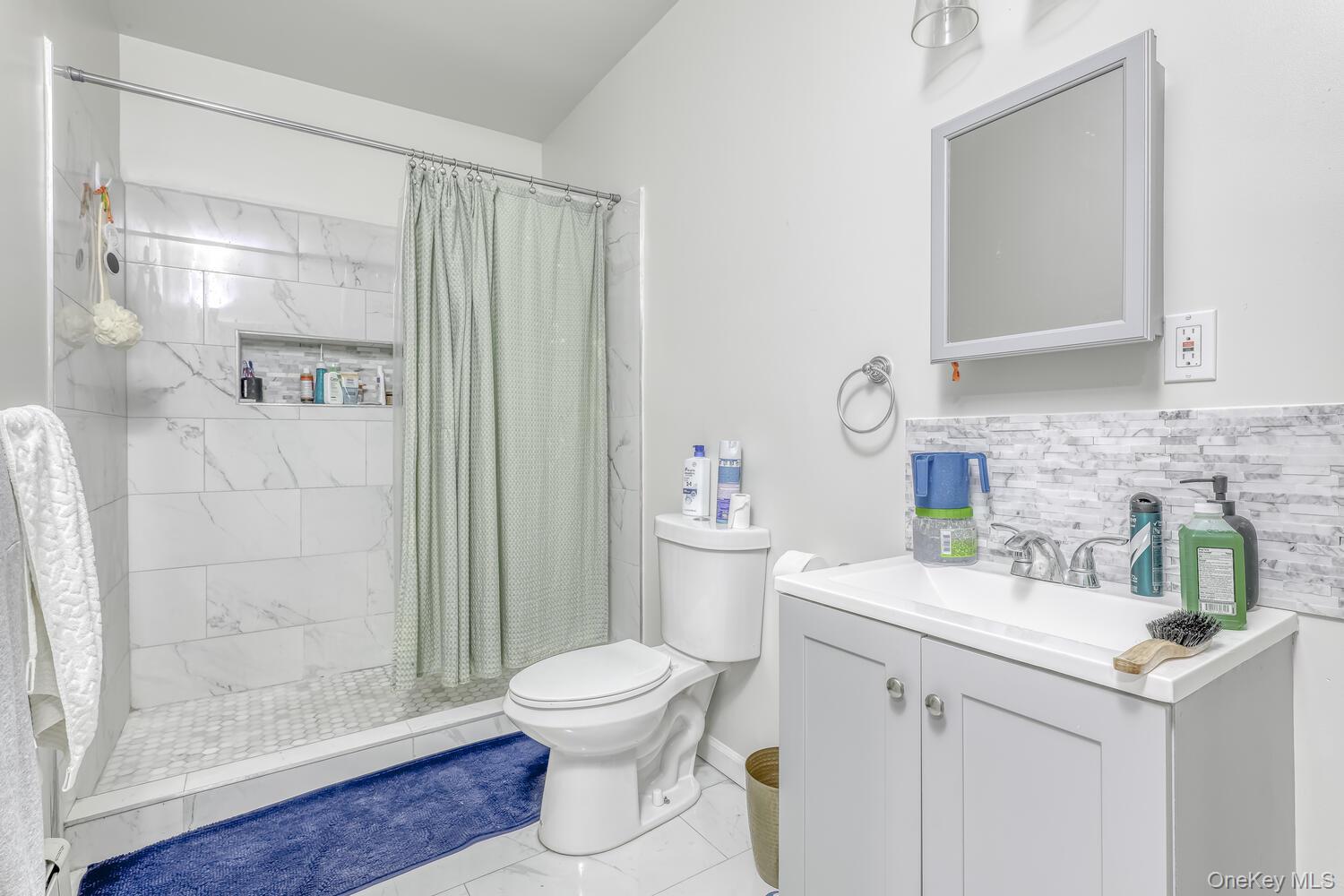 121 Thiells Road Stony Point, NY 10980 - Photo 26 of 34 a bathroom with a sink a toilet and shower