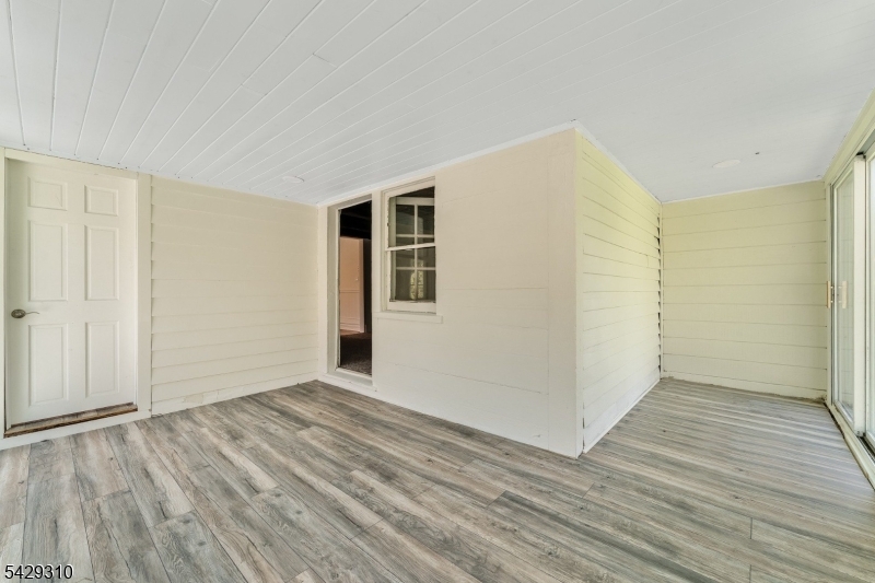 234 Cokesbury Califon Road Lebanon, NJ 08833 - Photo 27 of 46 an empty room with wooden floor and windows