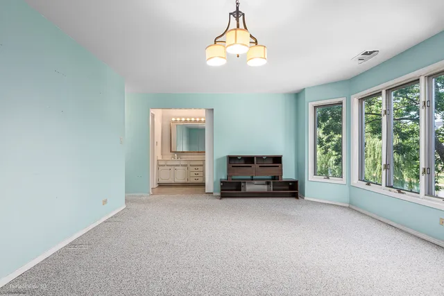 a view of empty room with fireplace and window