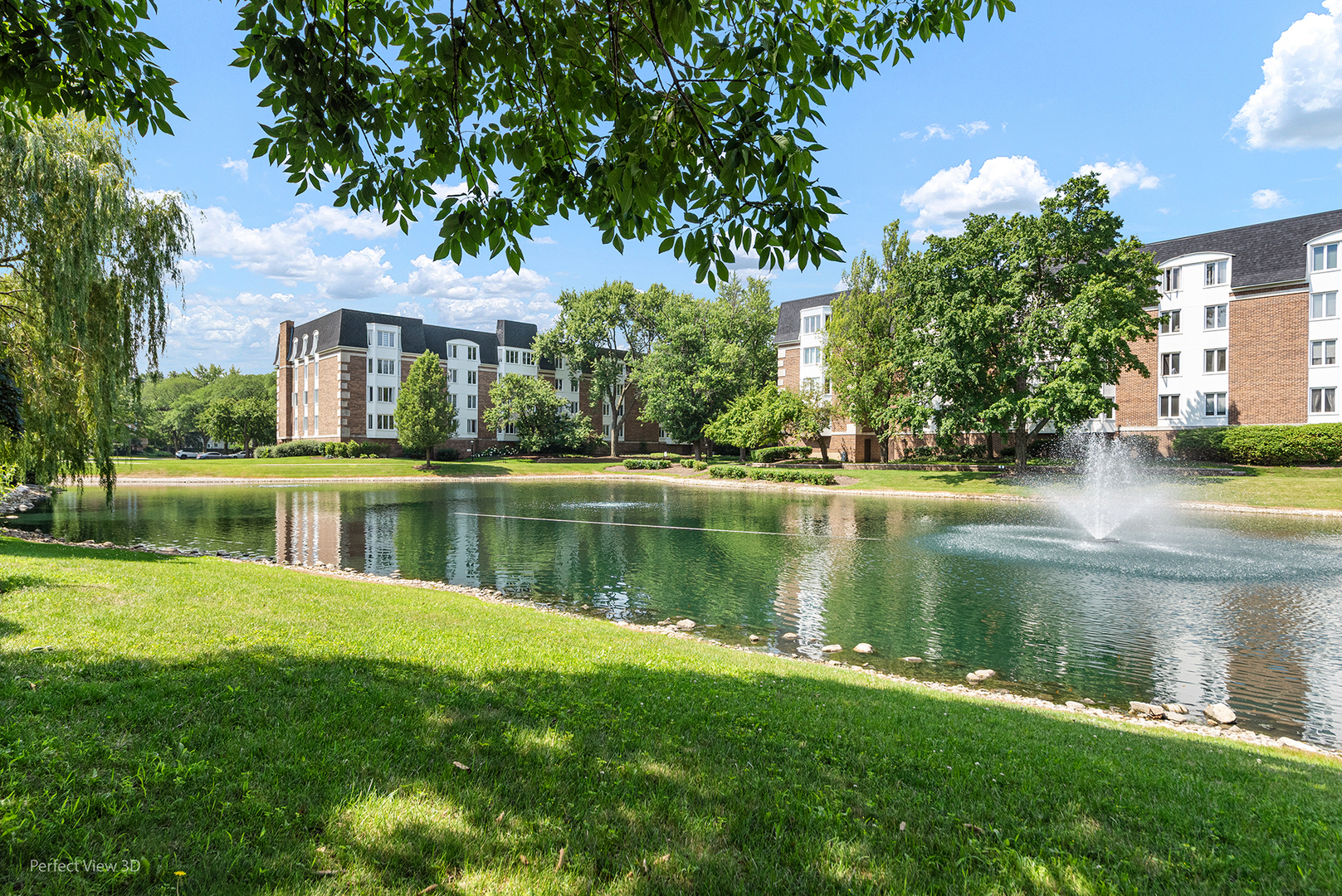 150 Lake Boulevard, Unit 125 Buffalo Grove, IL 60089 - Photo 26 of 30 a view of a house next to a lake with a big yard