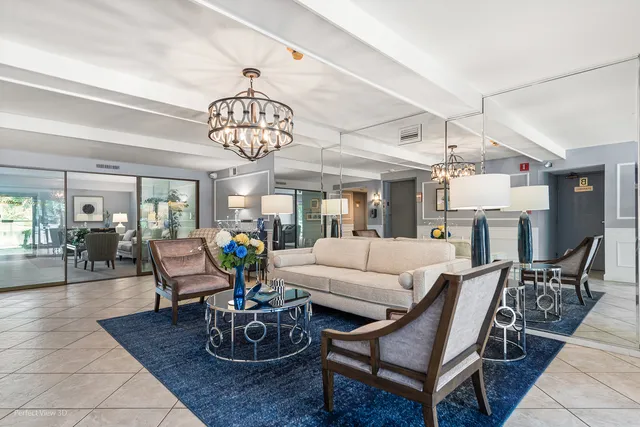 a living room with fireplace furniture and a chandelier