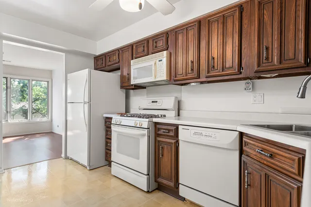a kitchen with stainless steel appliances granite countertop a refrigerator sink and cabinets