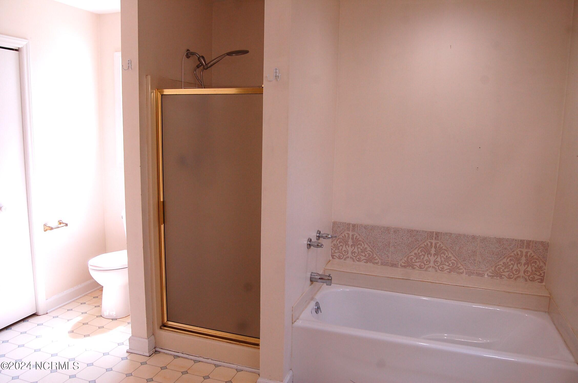 617 Lee Drive Havelock, NC 28532 - Photo 13 of 20 Even with all of th fixtures in the bathroom there is still room for an additional ottoman, bench or even a storage piece.