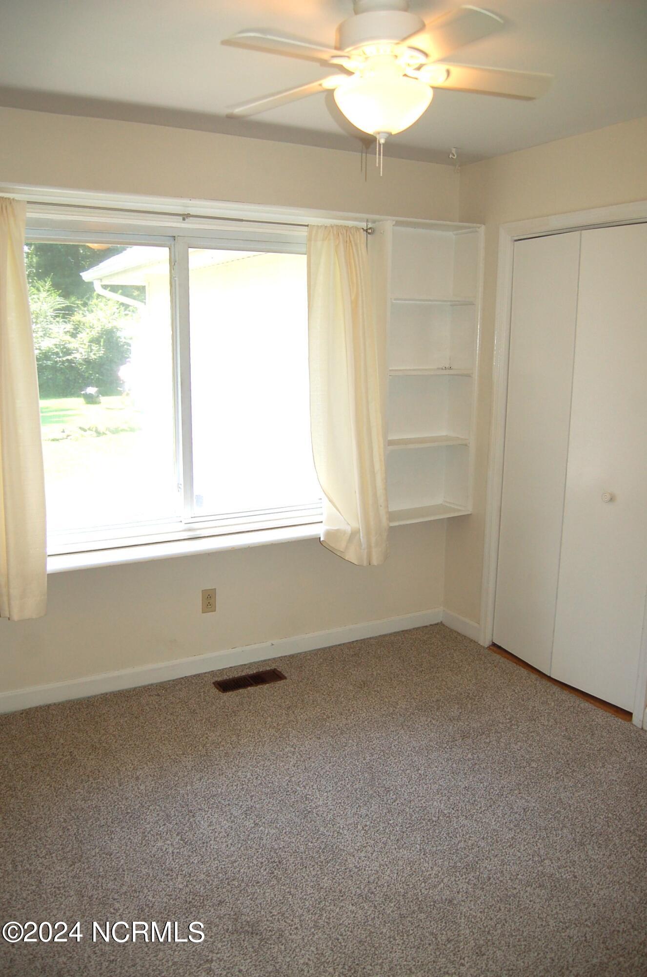 617 Lee Drive Havelock, NC 28532 - Photo 16 of 20 This bedroom overlooks the backyard and features 2 closets and two built in bookcases. The floor has new carpet and there is a ceiling fan.