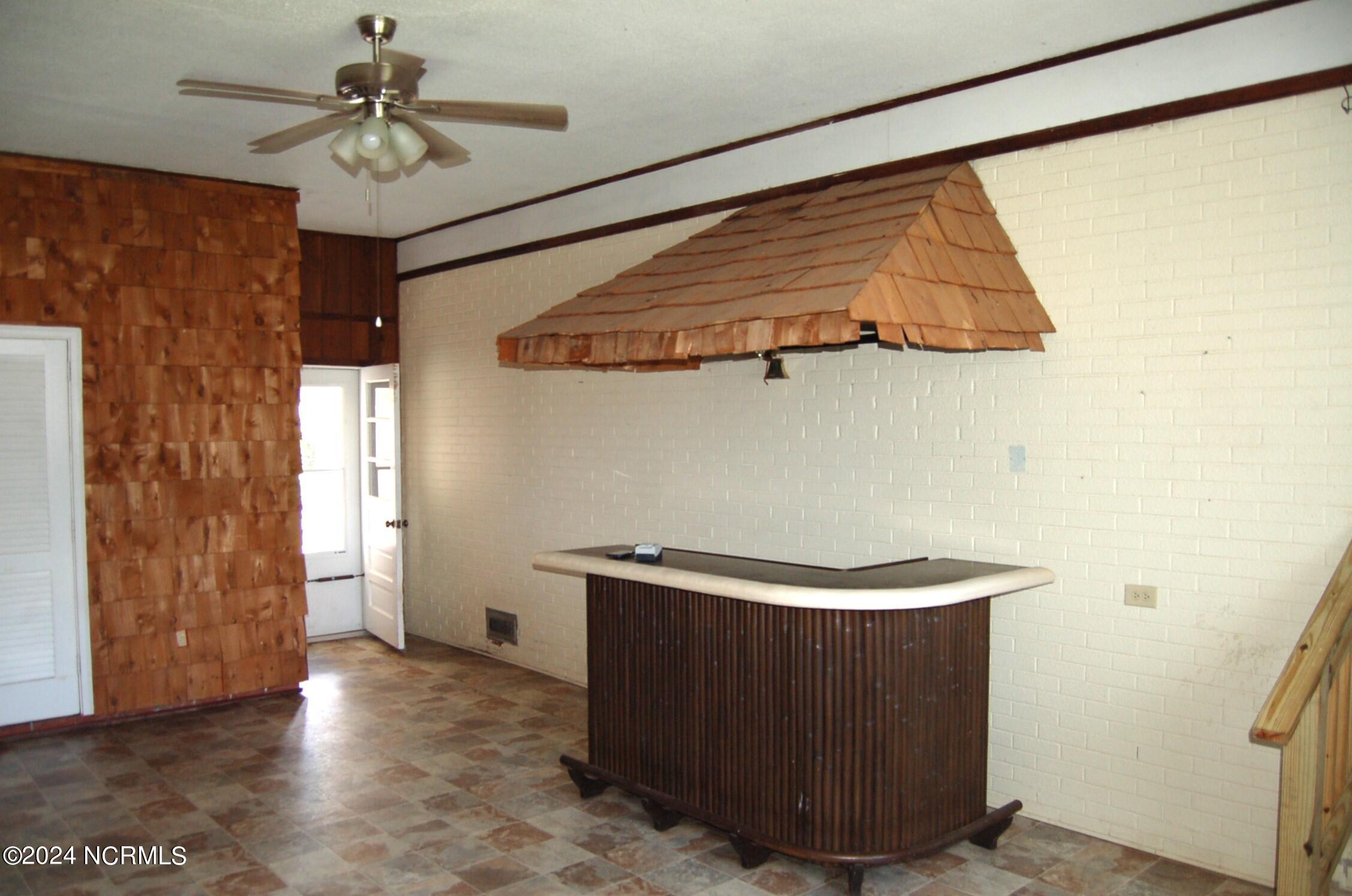 617 Lee Drive Havelock, NC 28532 - Photo 18 of 20 Nice vinyl flooring, large storage closet, tiki bar set up and door that leads to the backyard and to the laundry room.
