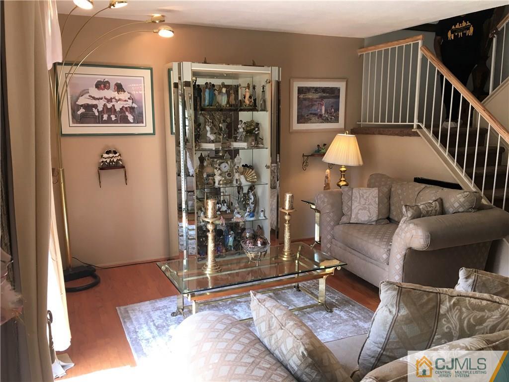 171 Salem Road North Brunswick, NJ 08902 - Photo 11 of 44 a living room with furniture and a painting on the wall